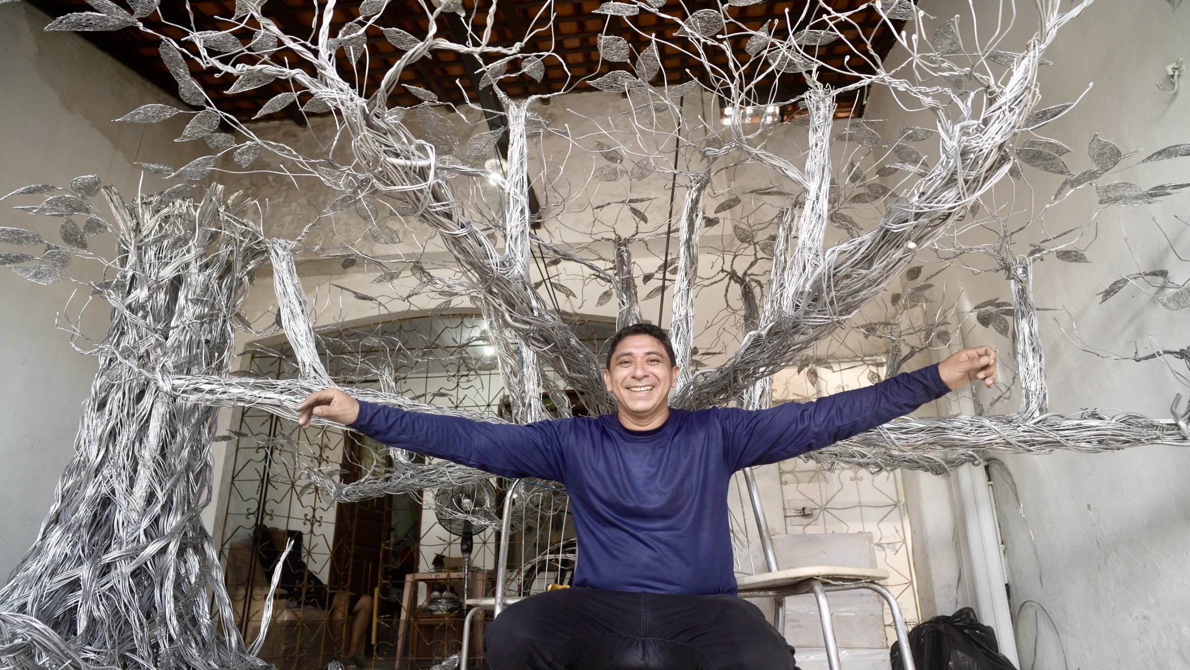 a man sitting in a chair with his arms stretched out