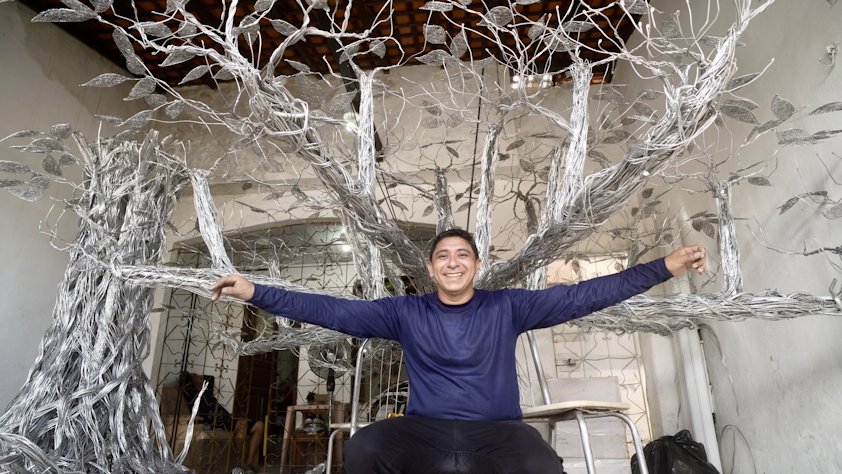 a man sitting in a chair with his arms stretched out