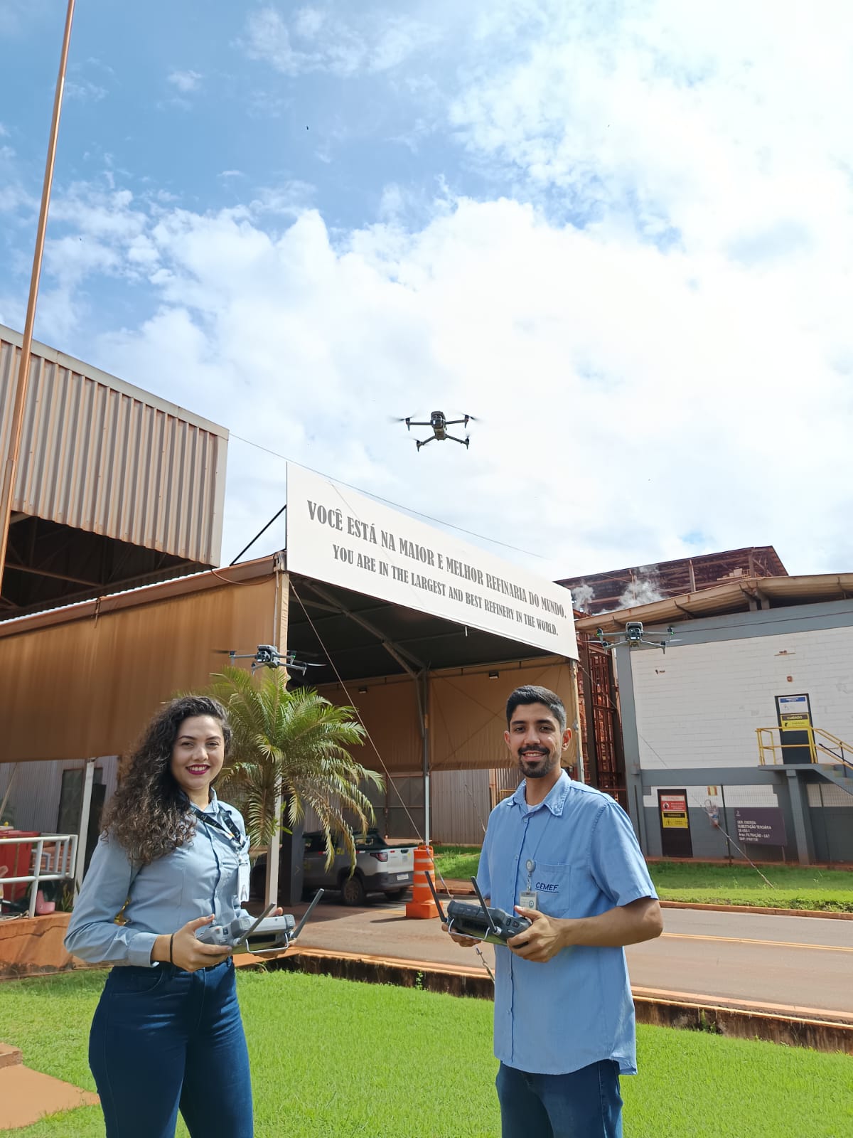 a man and woman holding remote controls in front of a building