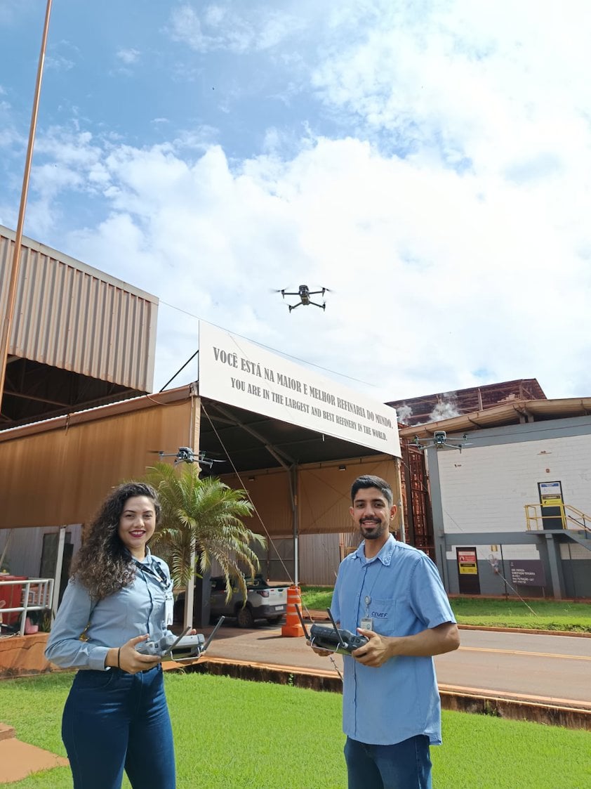 a man and woman holding remote controls in front of a building