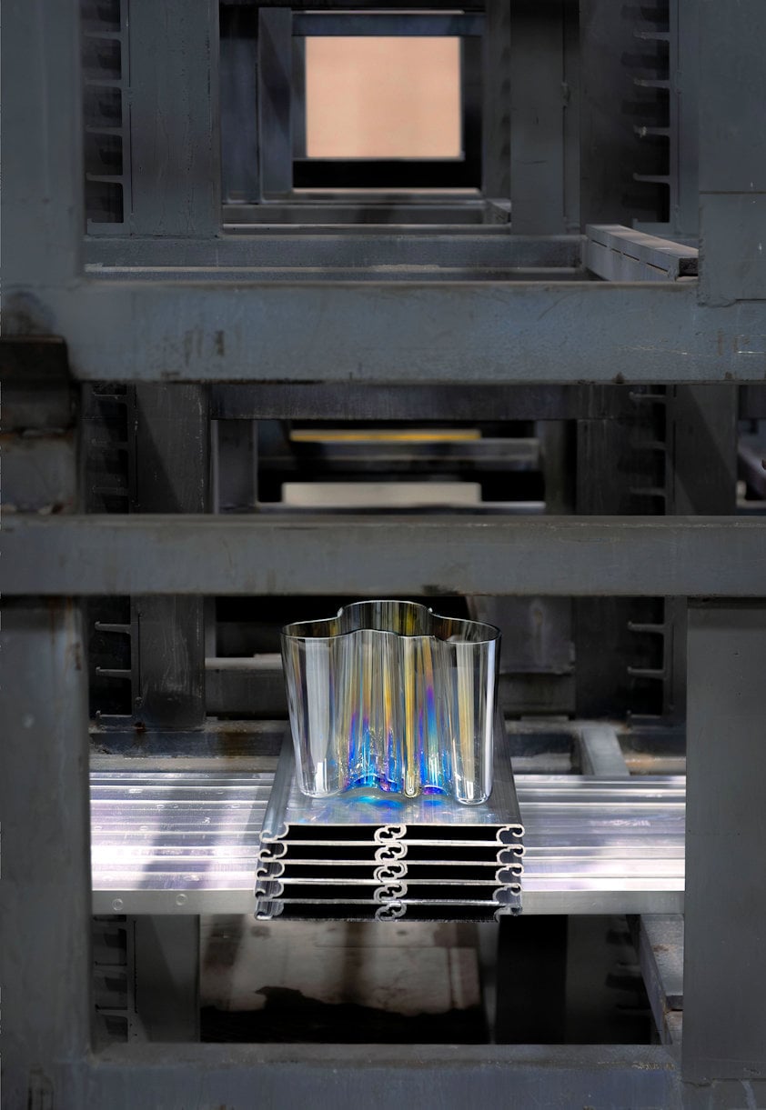 a aluminium vase on a metal shelf