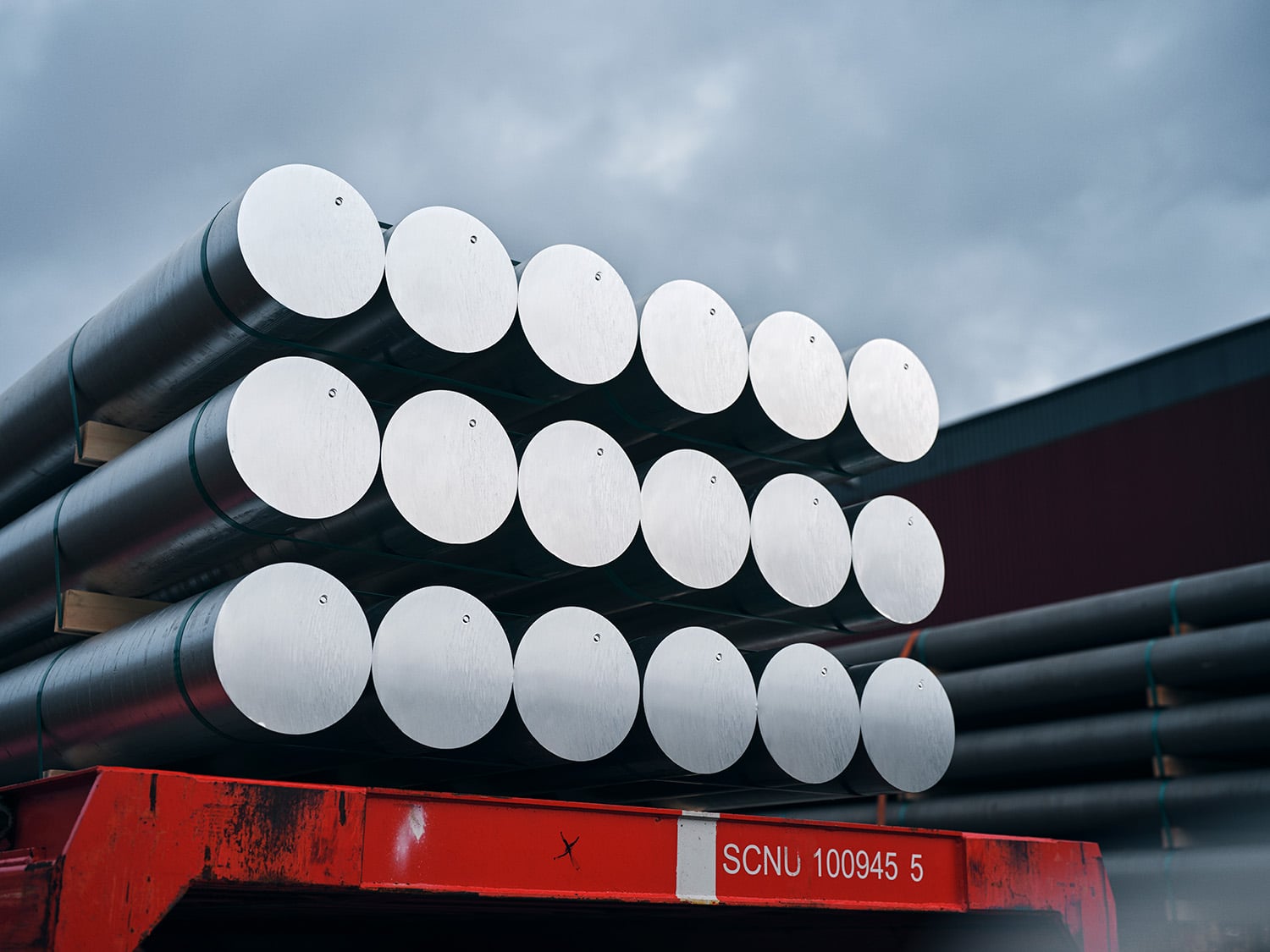 a stack of round metal rods on a trailer