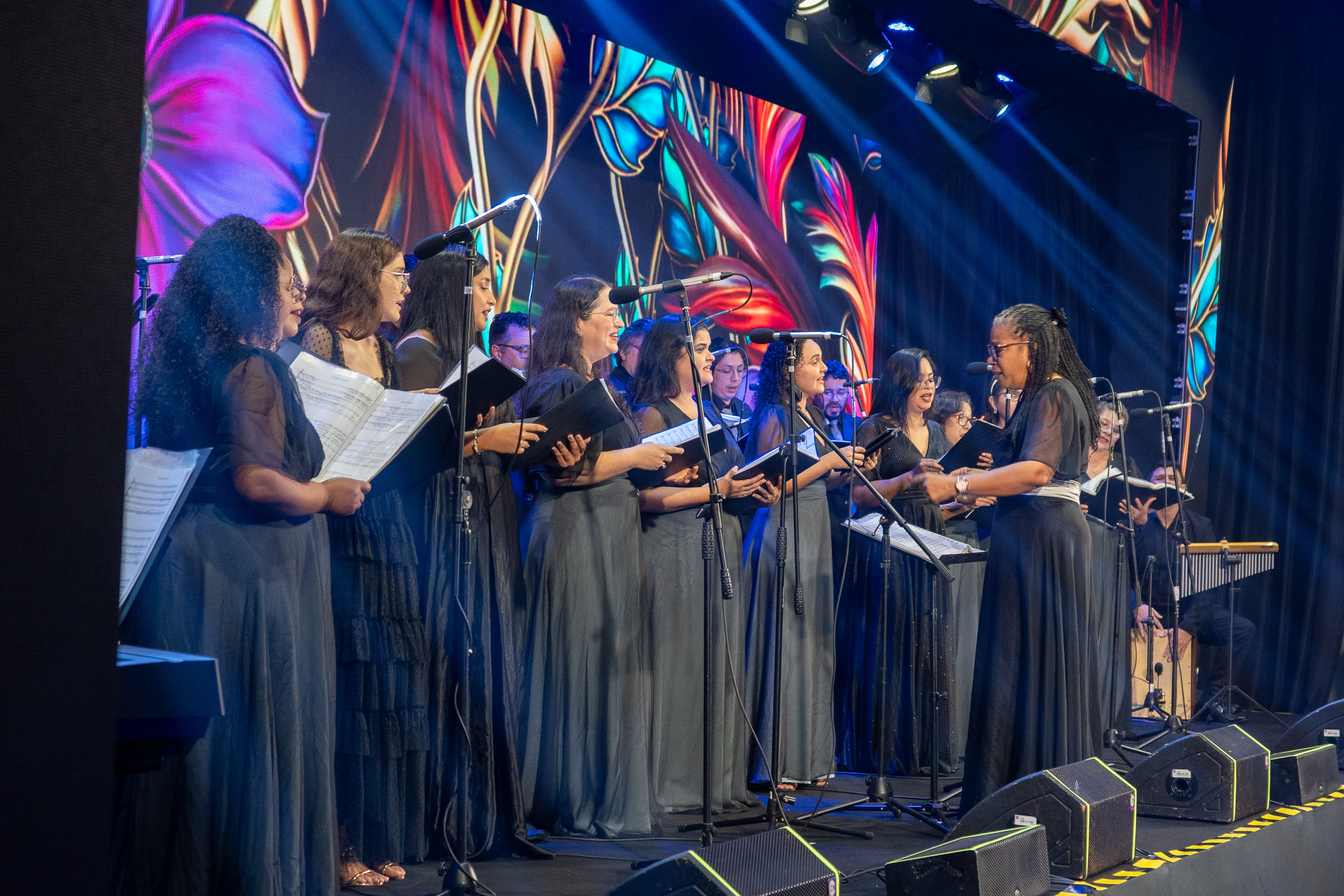 a group of women singing on stage
