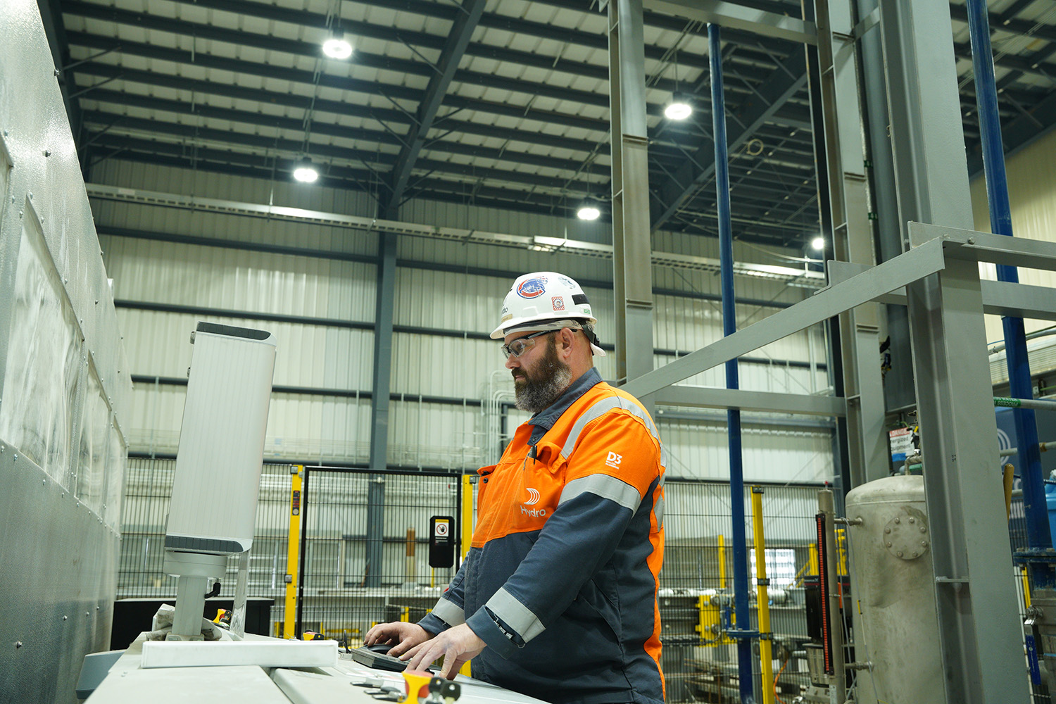 a man in a hard hat and orange jacket