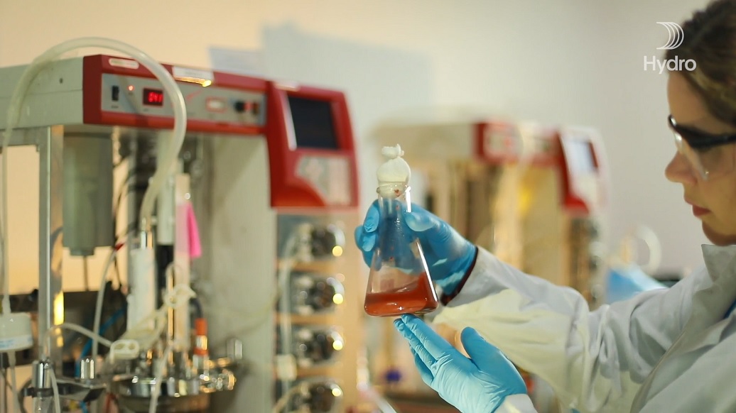 Chemist observing test tube in the laboratory.