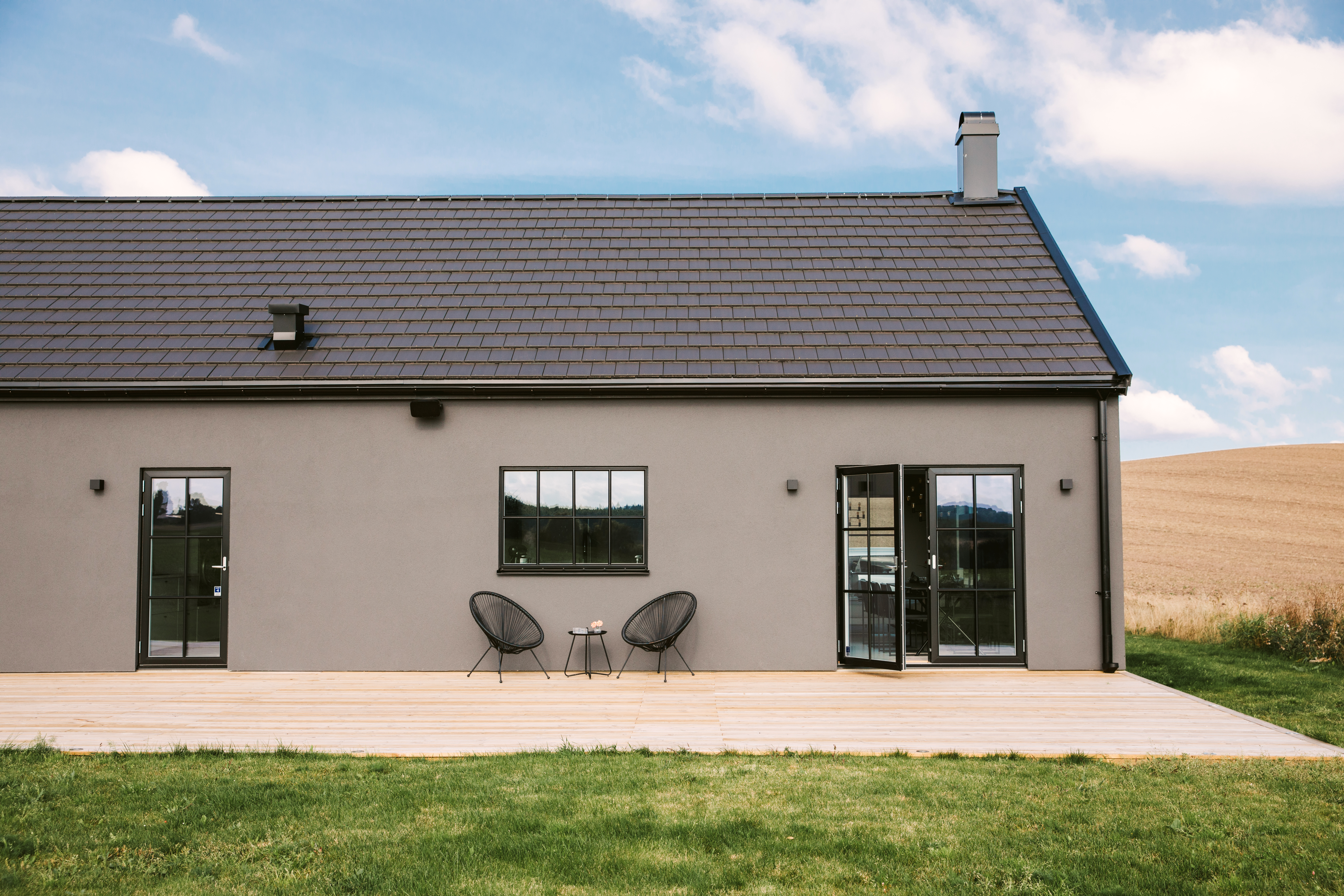 a house with a lawn and chairs