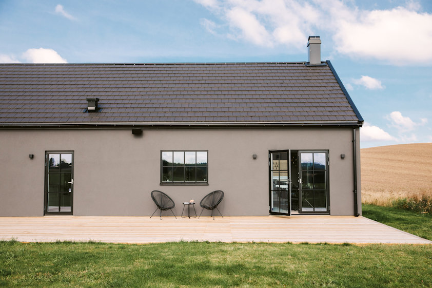 a house with a lawn and chairs