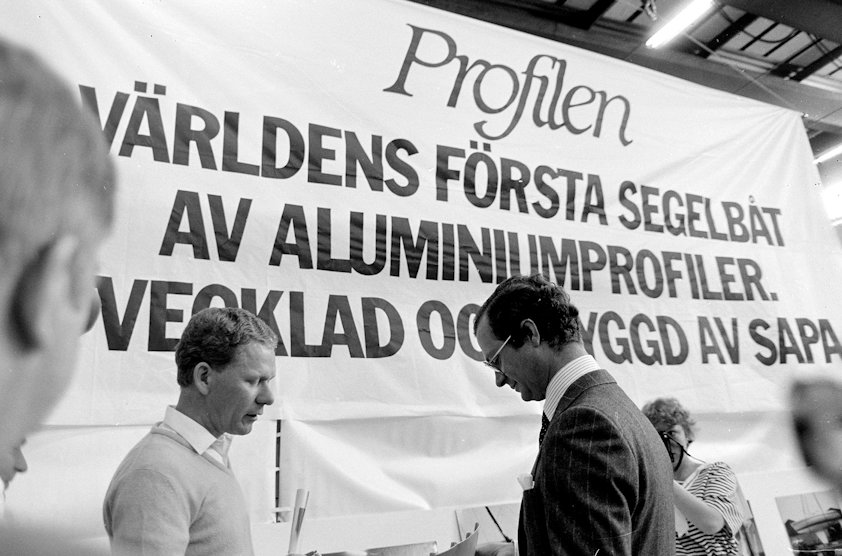 a man standing next to a sign