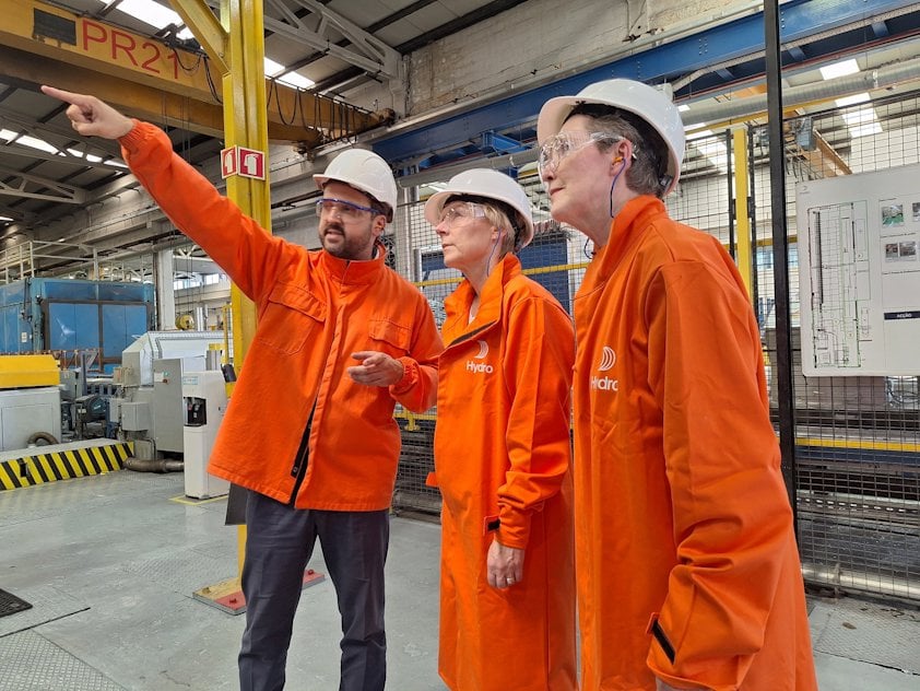 a group of men in orange jackets