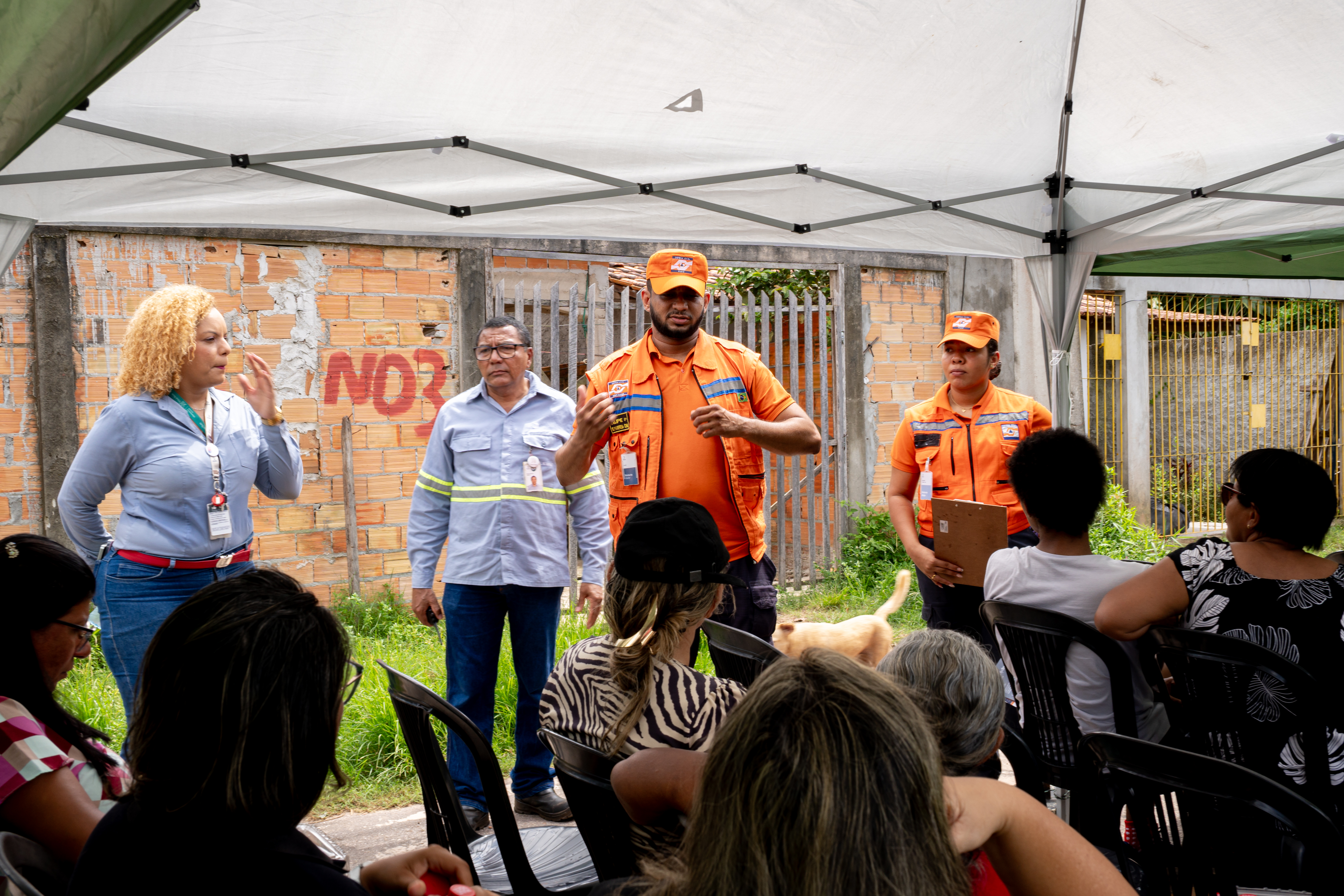 a group of people in orange uniforms standing in front of a crowd