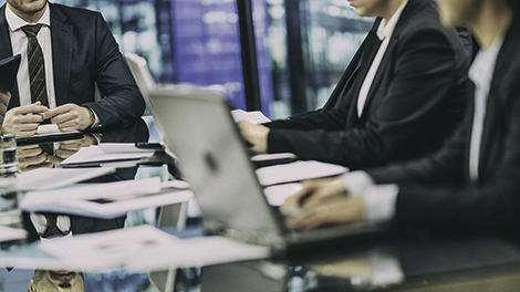 people with laptops in a meeting