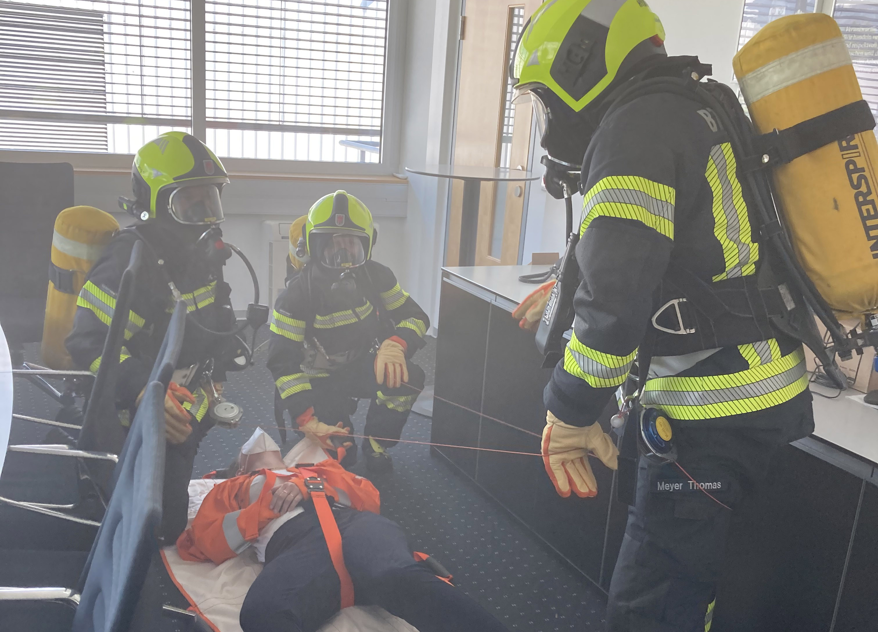 a group of firefighters attending to a patient