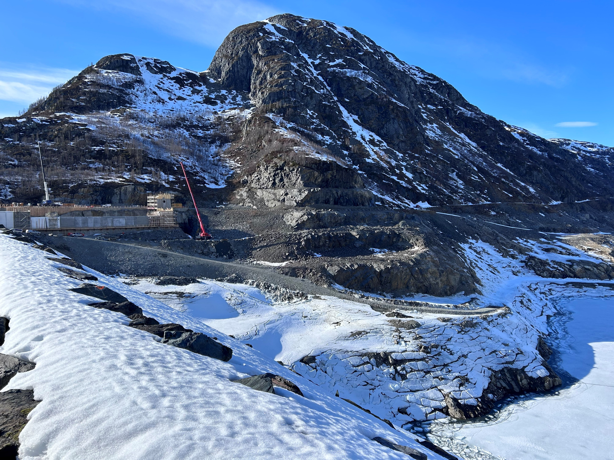 a mountain with snow and a building