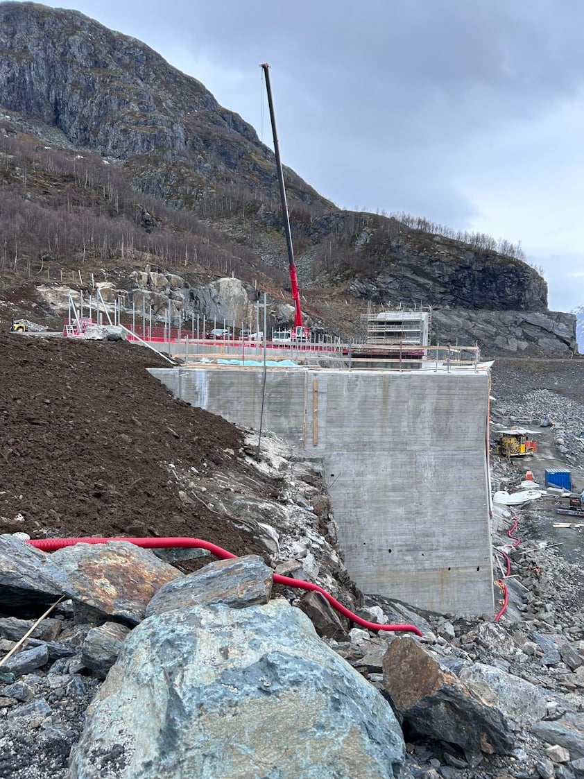 a construction site with a large hill and rocks