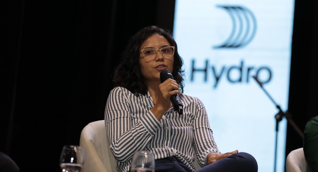 a woman speaking into a microphone
