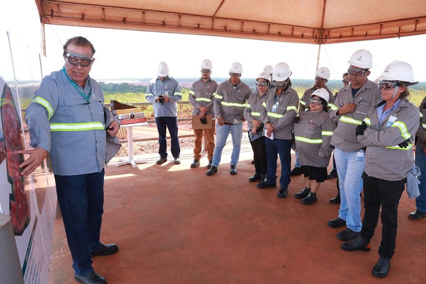 a group of people wearing hardhats and standing in a room