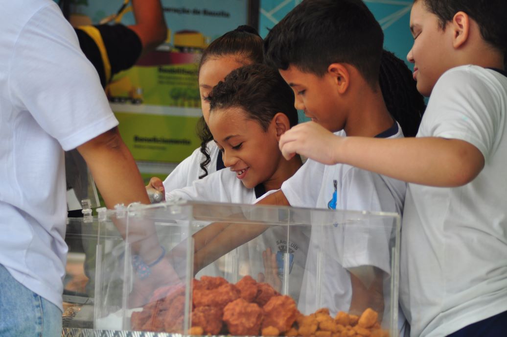 a group of people looking at a tray of food