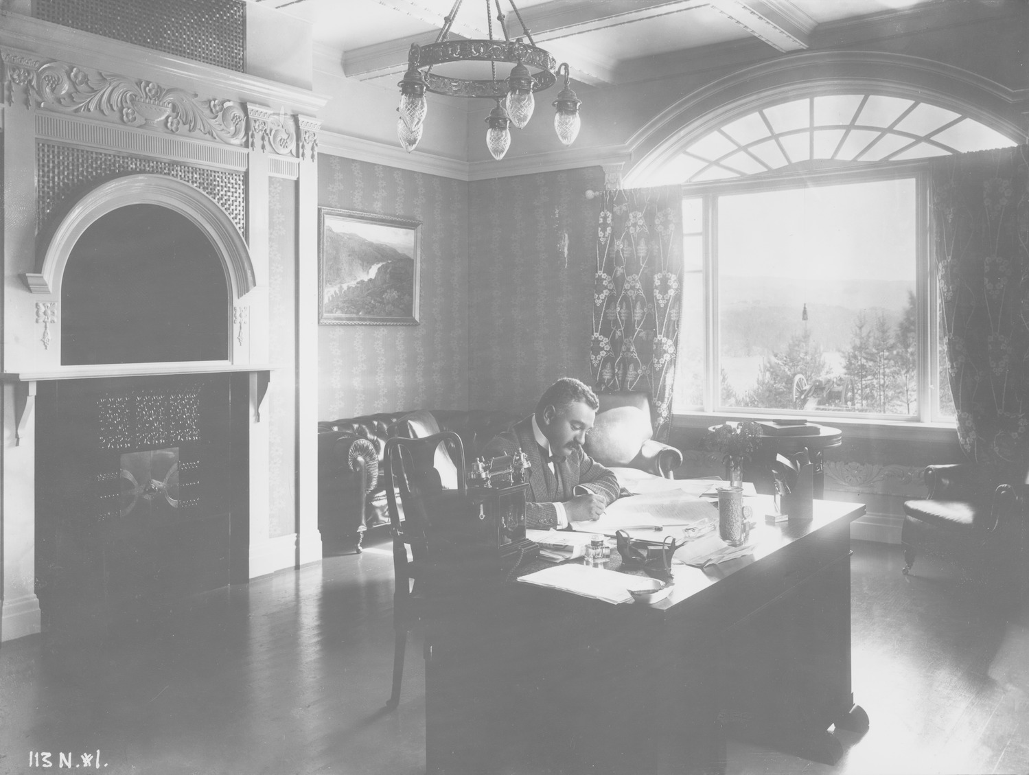 Hydro co founder Sam Eyde sitting at a desk, writing