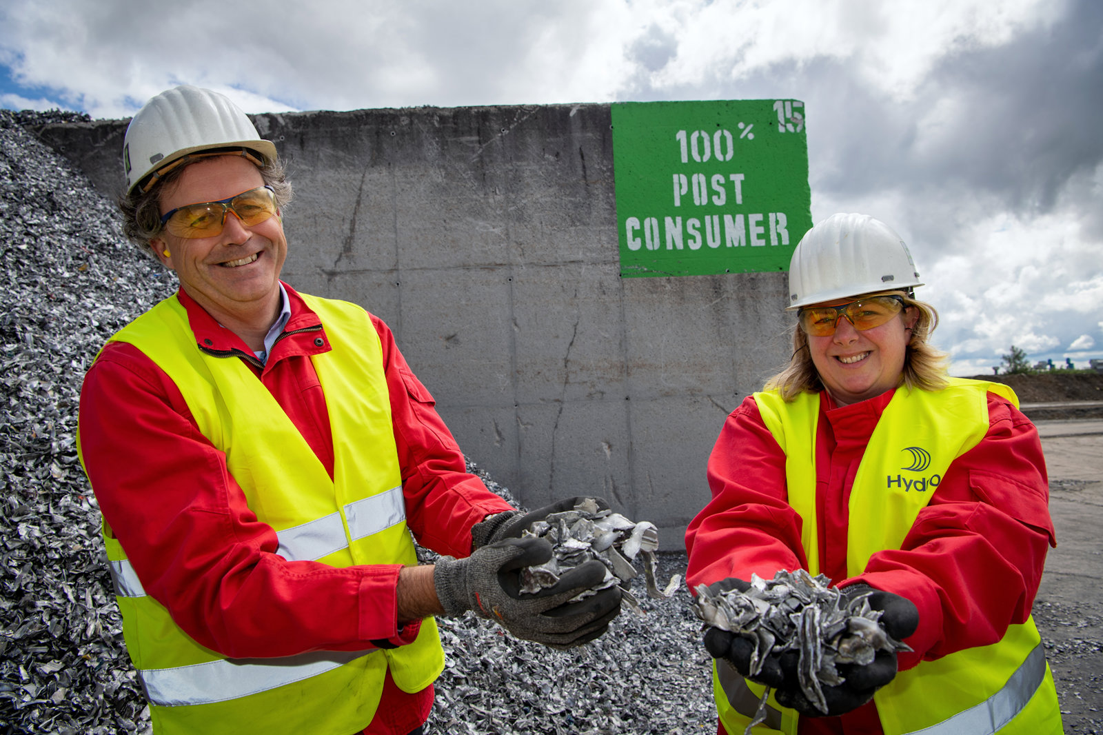 a man and woman wearing hard hats and holding a fish