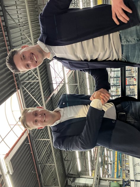 a couple of men smiling