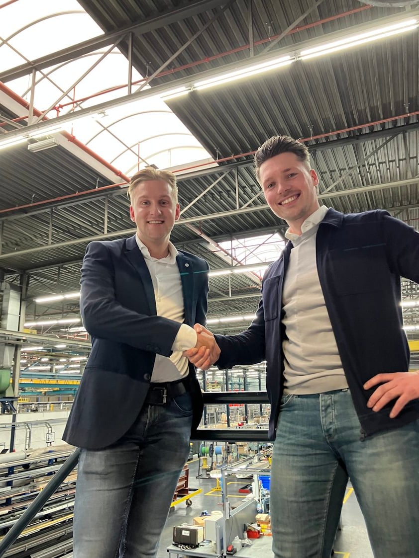 a couple of men smiling