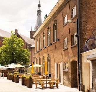 a brick building with tables and chairs