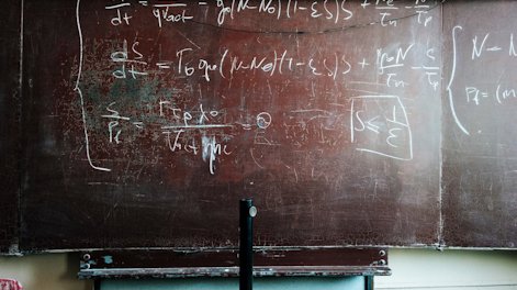 a worn blackboard with science  equations
