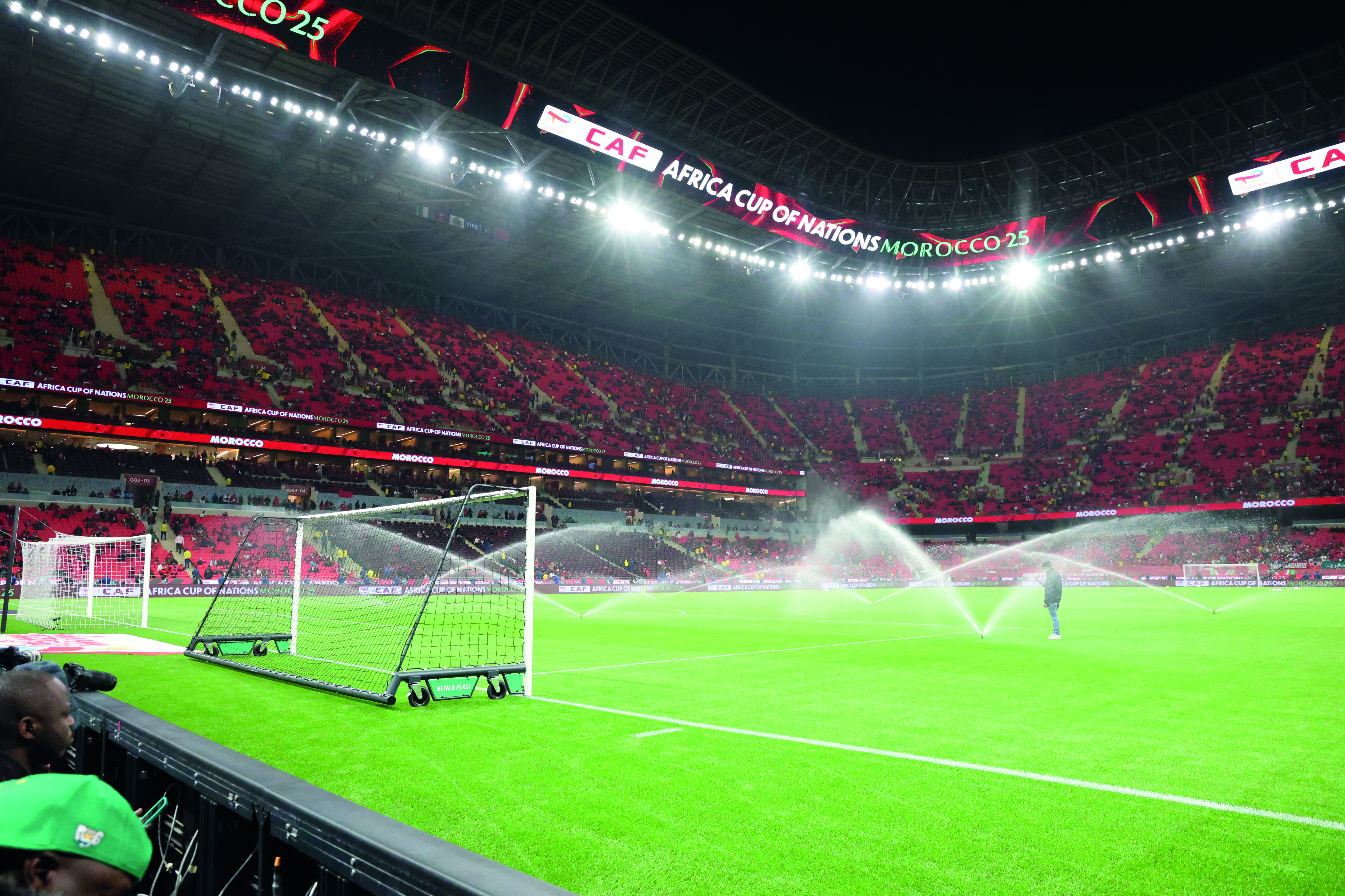 a football field with sprinklers spraying water
