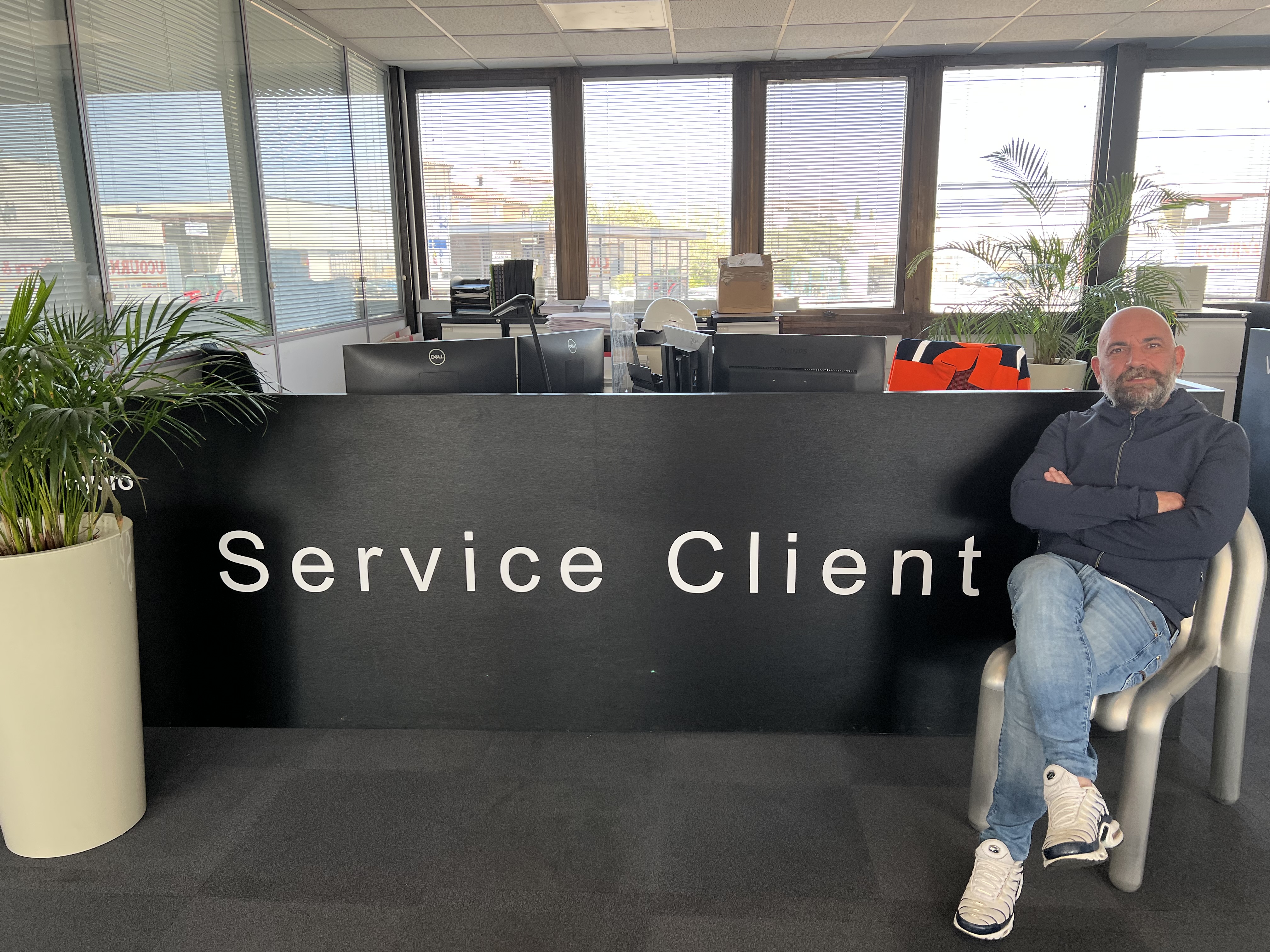 a person sitting in a chair in front of a sign