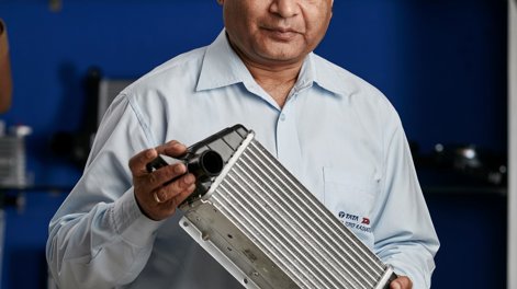 Ravi Chidambar holding a heat exchanger