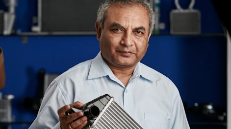 Ravi Chidambar holding a heat exchanger