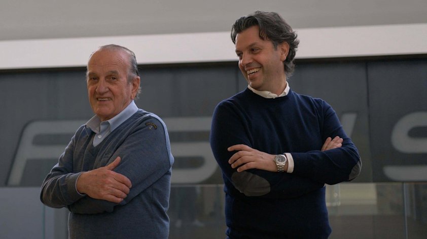 a couple of men smiling