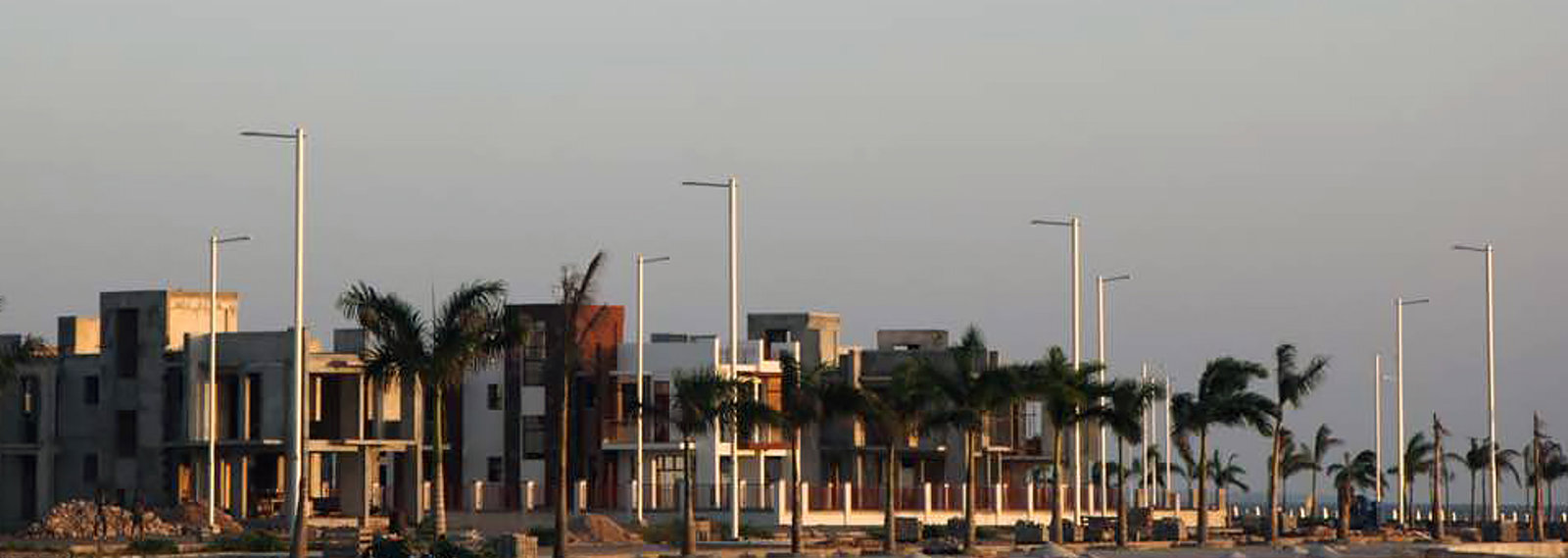 residential buildings, light poles and palms