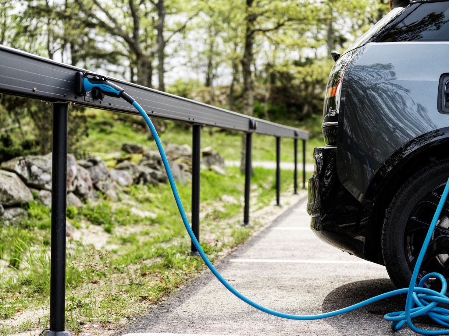 a car parked next to a fence