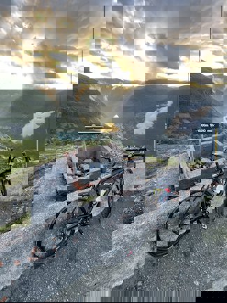 a bicycle parked next to a sign