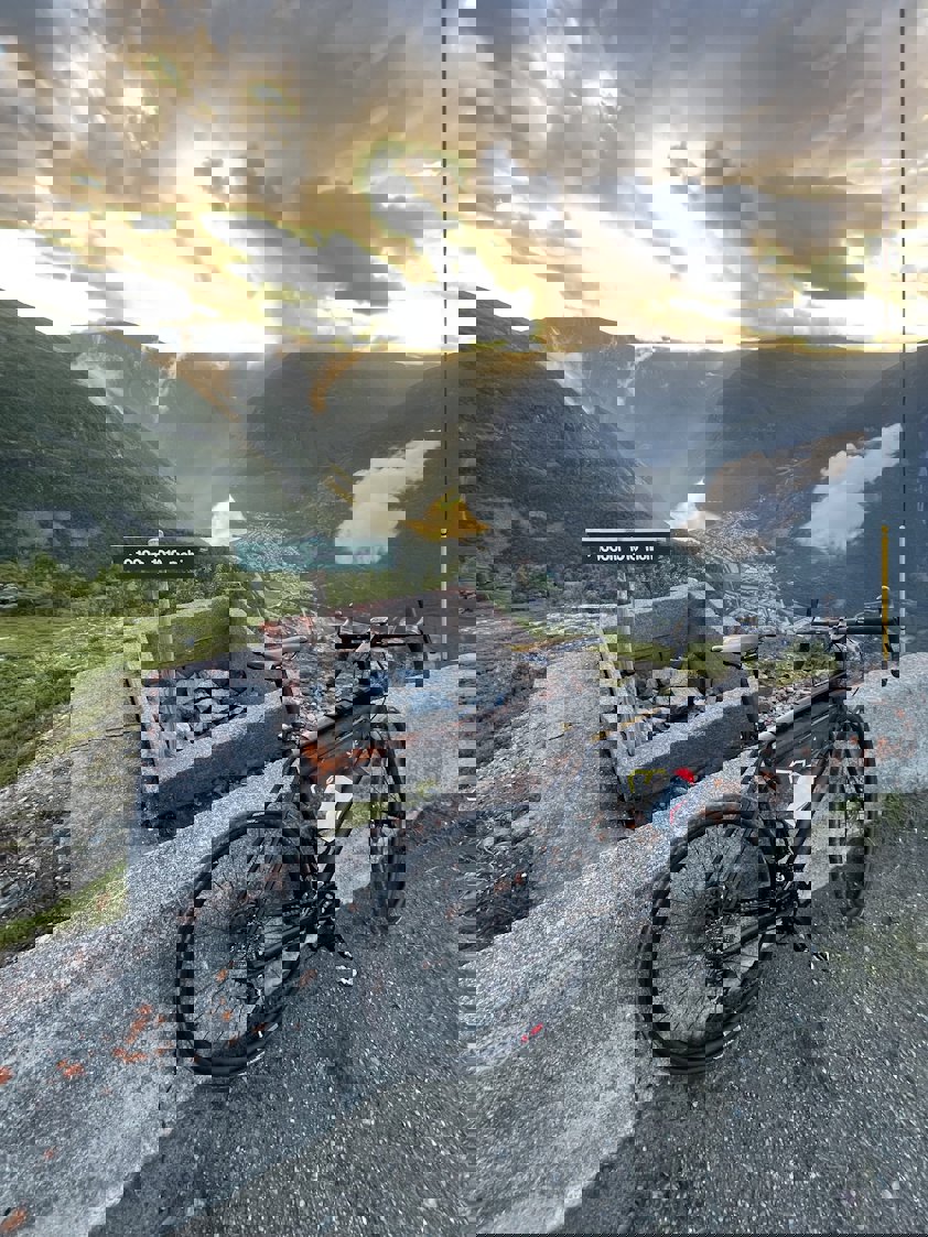 a bicycle parked next to a sign