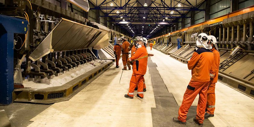 a group of people in orange suits