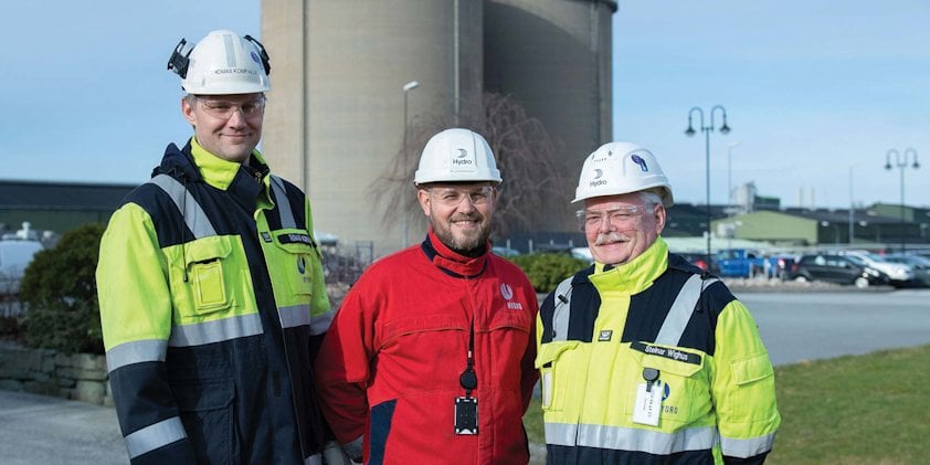 a group of men wearing hardhats and reflectors