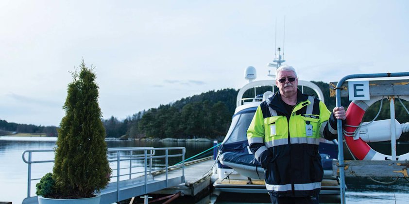 a man in a life jacket standing on a boat