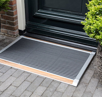 a grill outside by a plant