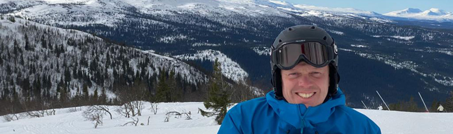 a man wearing a helmet and goggles in the snow