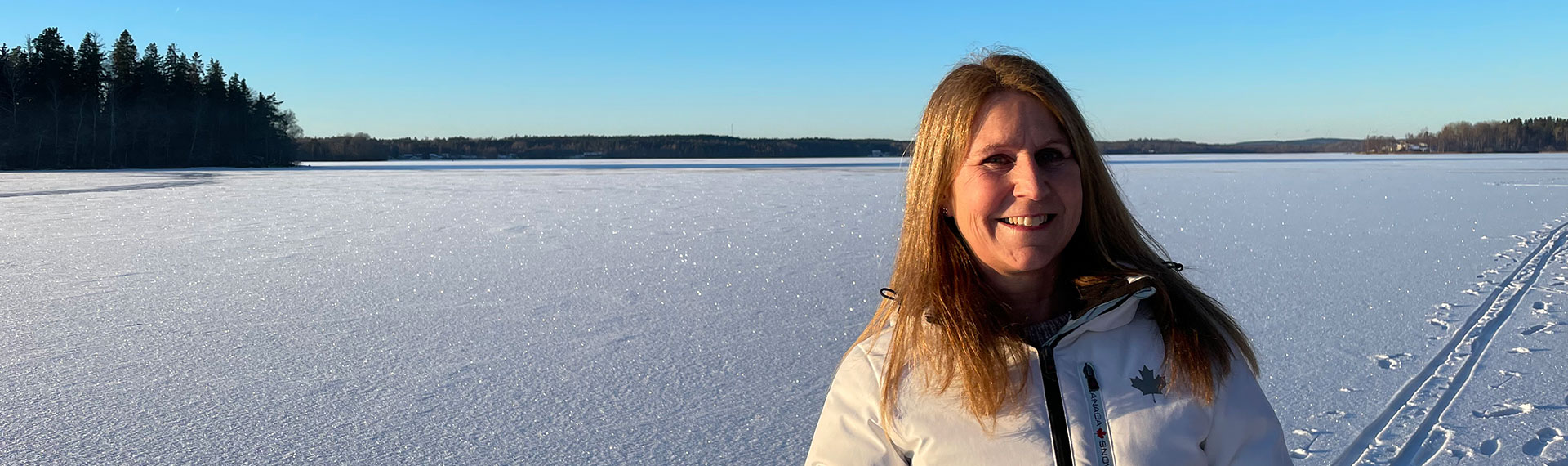 a woman standing in a snowy field