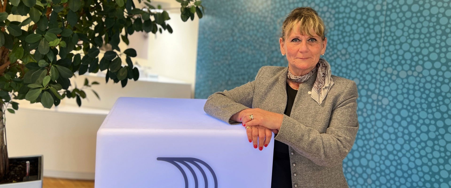 a man standing next to a plant