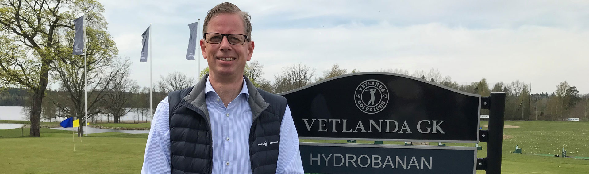 a man standing in front of a sign