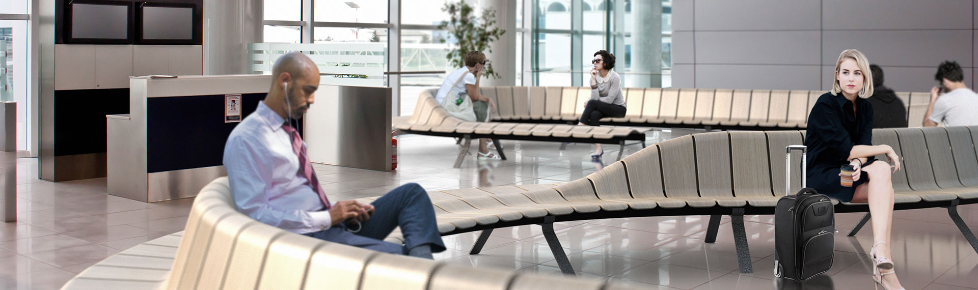 a group of people sitting on a bench in a large room