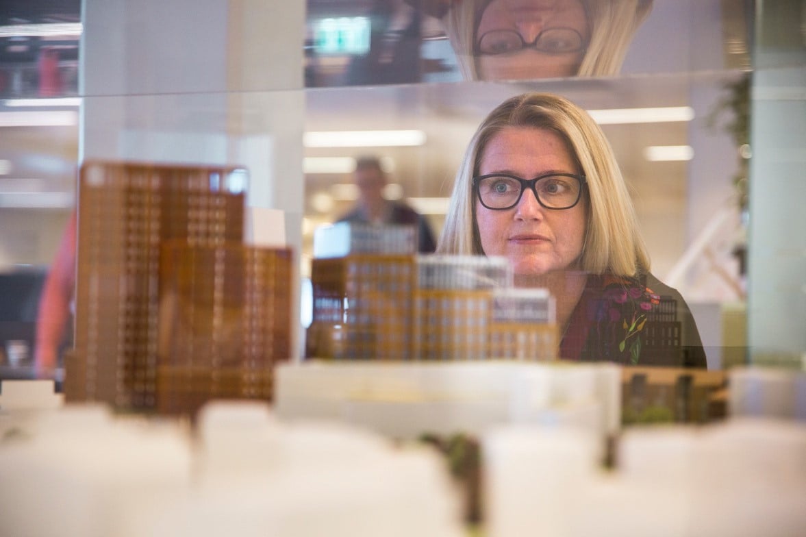 Unni Hofstad behind a scale model of office buildings