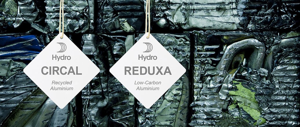 Hydro CIRCAL and Hydro REDUXA hangtags hanging on aluminium scrap Hydro CIRCAL and Hydro REDUXA hangtags hanging on aluminium scrap
