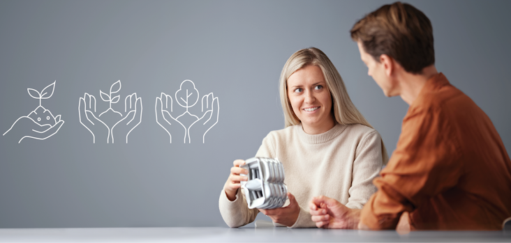 Two persons sitting at the table discussing an aluminium profile Two persons sitting at the table discussing an aluminium profile