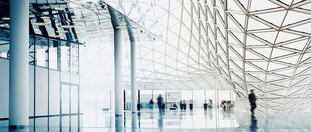 interior of a large building with huge glass windows in triangular sections