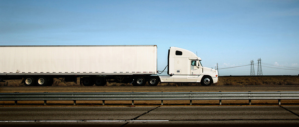 White truck on the road under blue sky White truck on the road under blue sky